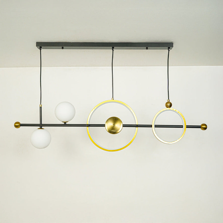 Contemporary linear chandelier with gold ring design and white glass globe mounted on black rod ideal for stylish dining or kitchen lighting.