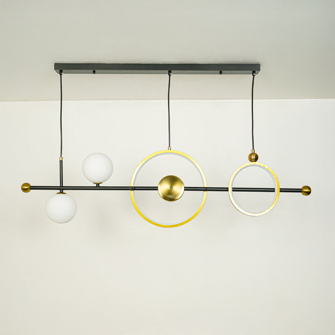 Contemporary linear chandelier with gold ring design and white glass globe mounted on black rod ideal for stylish dining or kitchen lighting.