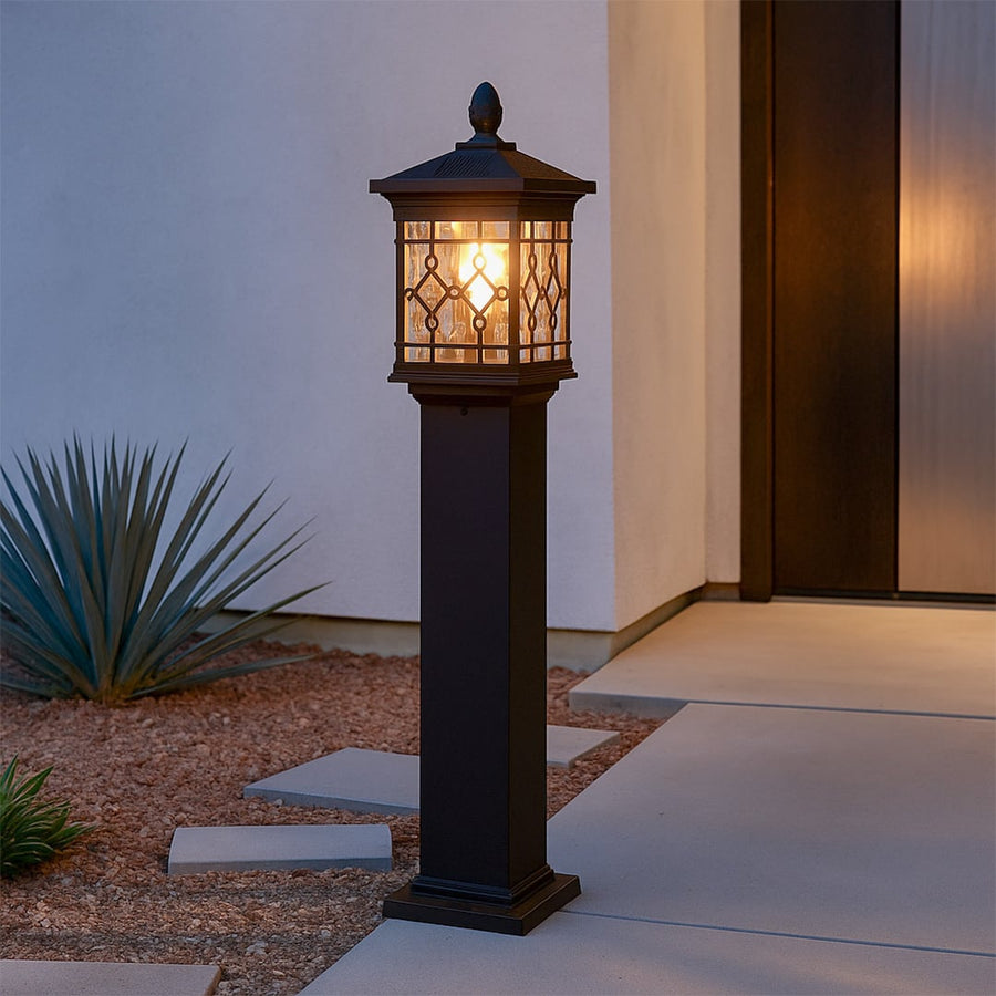 Black solar outdoor gate light with warm glow styled beside pathway for elegant exterior decor ambiance.