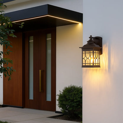 Vintage outdoor wall lantern displayed in a simple lifestyle setting with decorative textured glass and classic metal detailing.