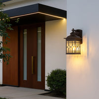 Vintage outdoor wall lantern displayed in a simple lifestyle setting with decorative textured glass and classic metal detailing.