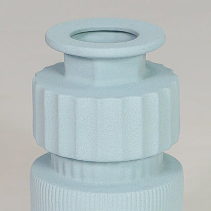 Closeup light blue ceramic textured vase detail modern ribbed decorative flower vase for table shelf console decor.