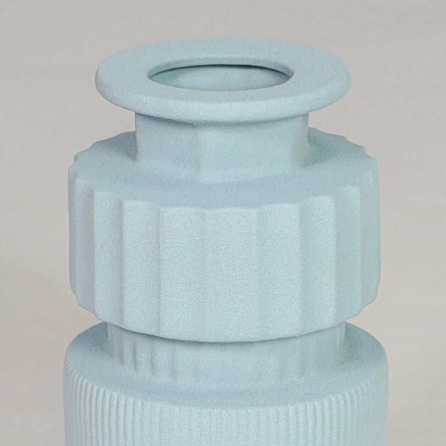 Closeup light blue ceramic textured vase detail modern ribbed decorative flower vase for table shelf console decor.