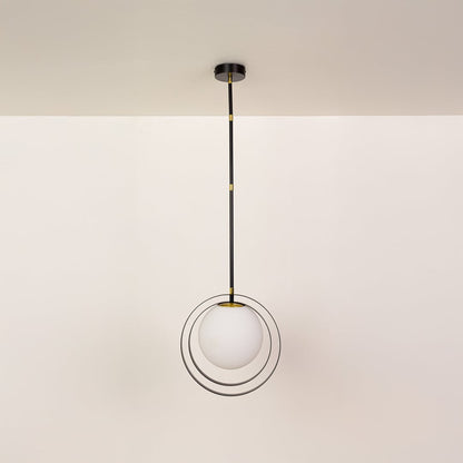 Black metal pendant light with white globe shown on a bright white background with lights off for a minimal modern look.