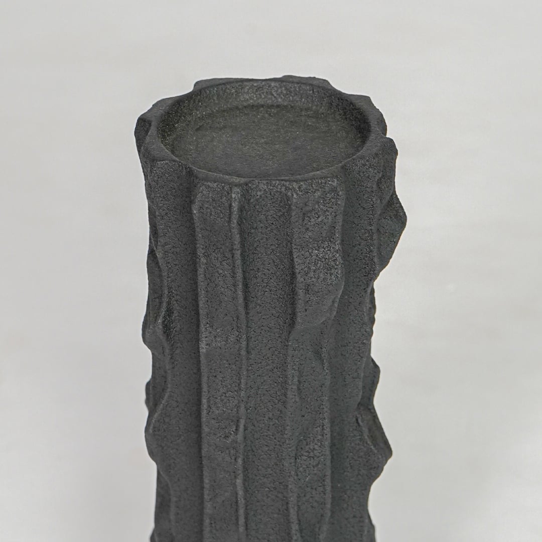 Closeup black textured ceramic candle holder surface detail modern decorative holder for table shelf console decor.