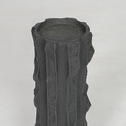 Closeup black textured ceramic candle holder surface detail modern decorative holder for table shelf console decor.