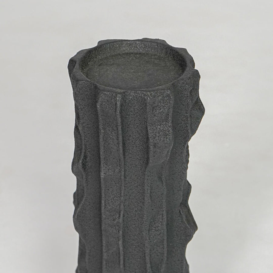 Closeup black textured ceramic candle holder surface detail modern decorative holder for table shelf console decor.