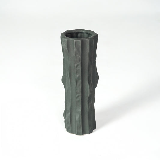 Black textured ceramic vase for modern shelf placement and elegant indoor home decor styling accent piece.