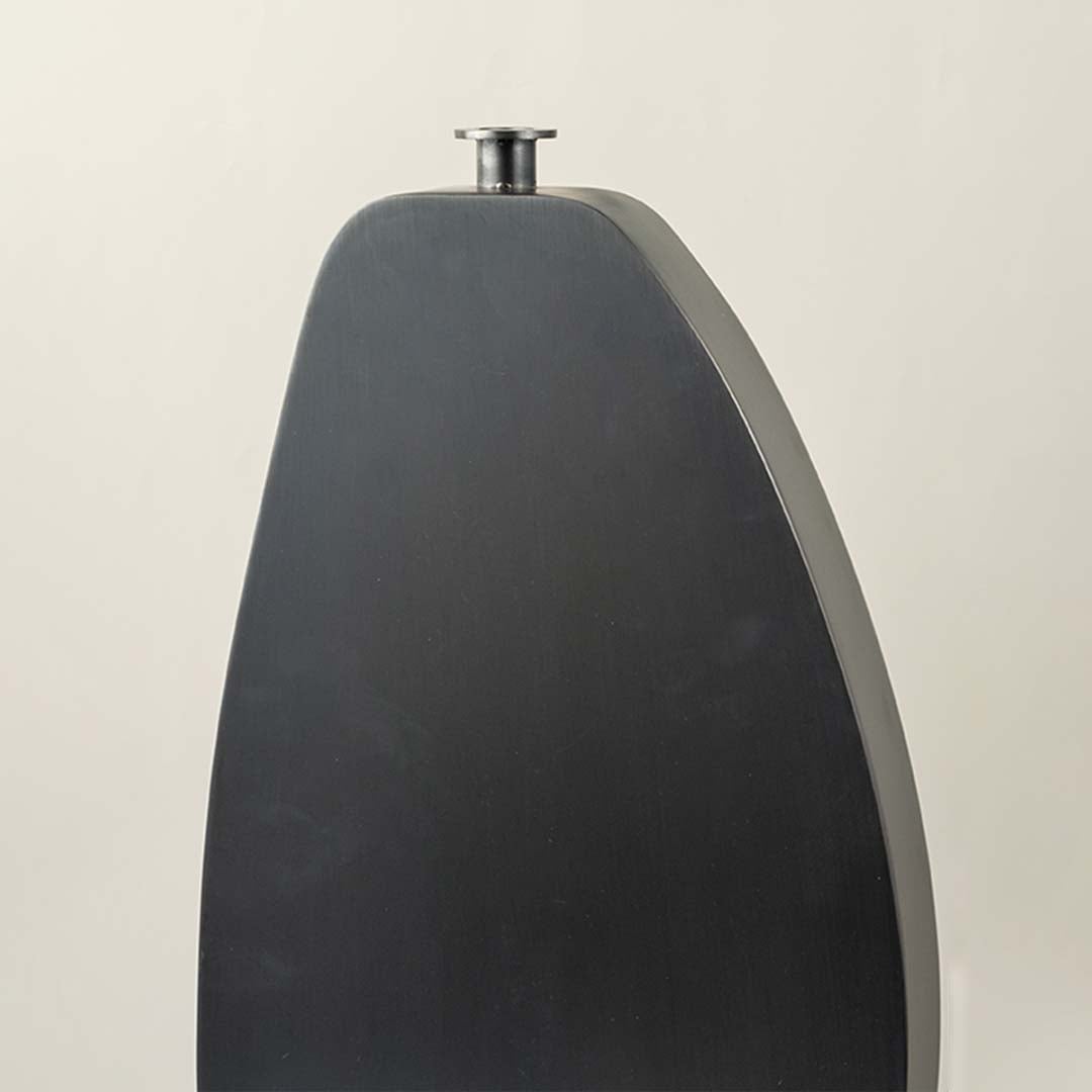 Closeup of black wooden vase showing smooth surface and minimal slim neck design for contemporary decor.