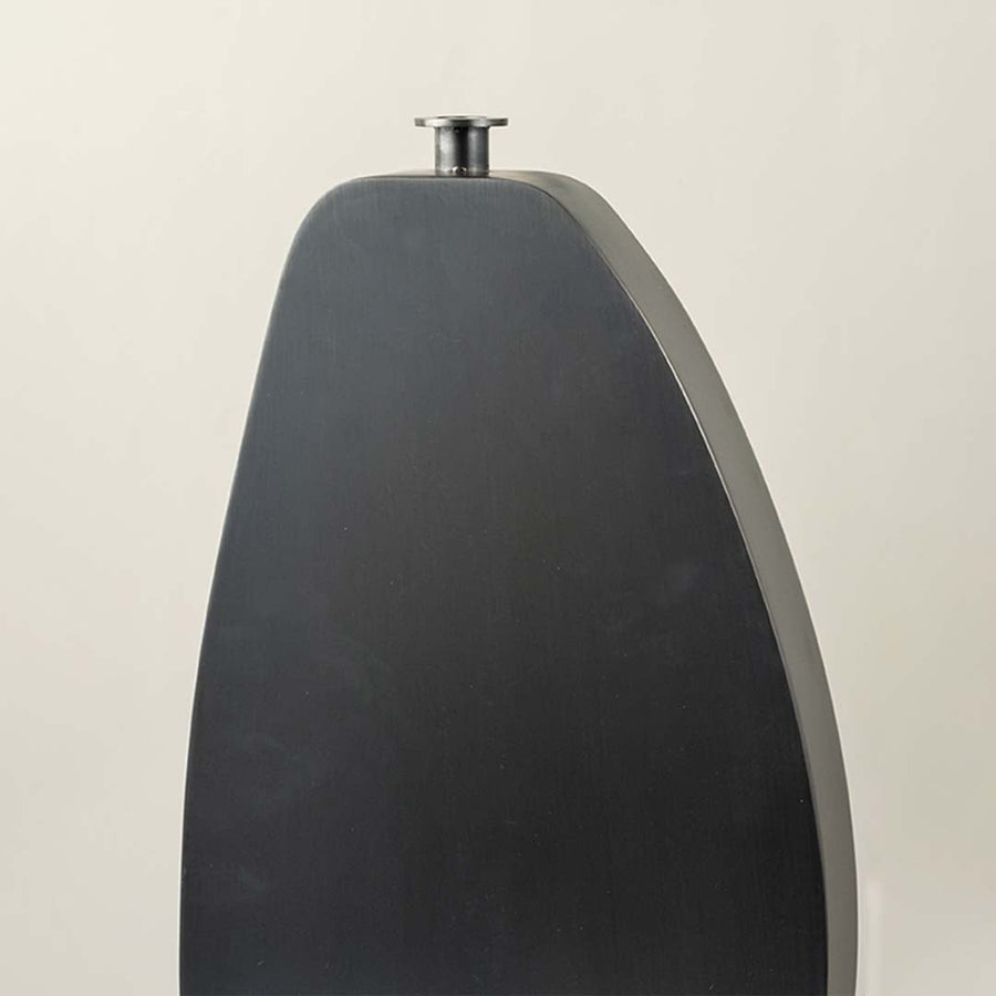 Closeup of black wooden vase showing smooth surface and minimal slim neck design for contemporary decor.