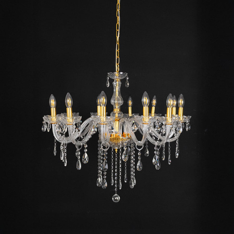 Chandelier with crystal and gold accents displayed off against black background for decorative modern home style.