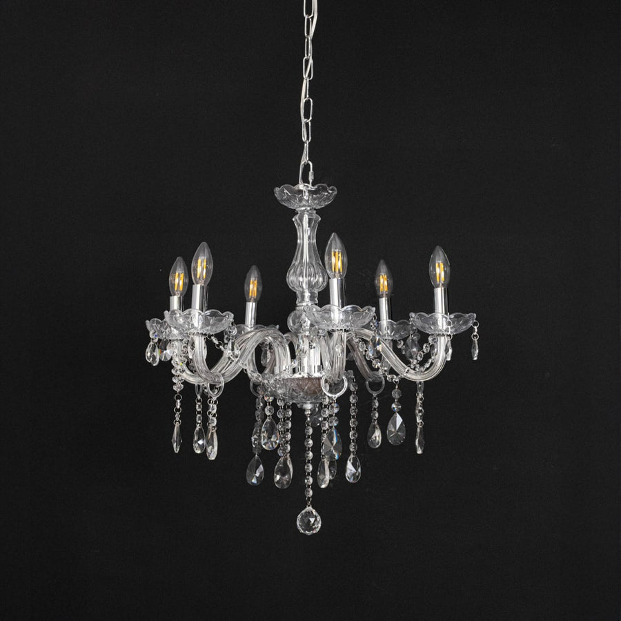 Crystal chandelier with lights off featuring decorative glass body and crystal hanging drops on black background.