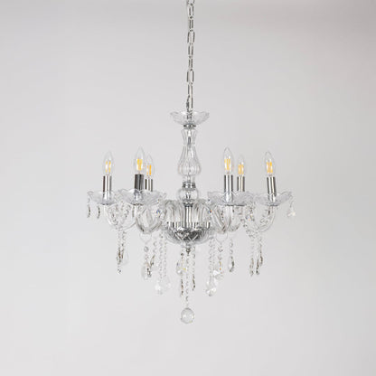 Crystal chandelier with lights off showing glass arms and crystal chains photographed on plain white background.