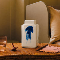 White ceramic decorative jar with blue koi artwork styled on a bedside table for elegant modern home decor settings.
