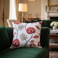 White cotton cushion cover with red floral print styled on a living room sofa for elegant modern home decor inspiration.