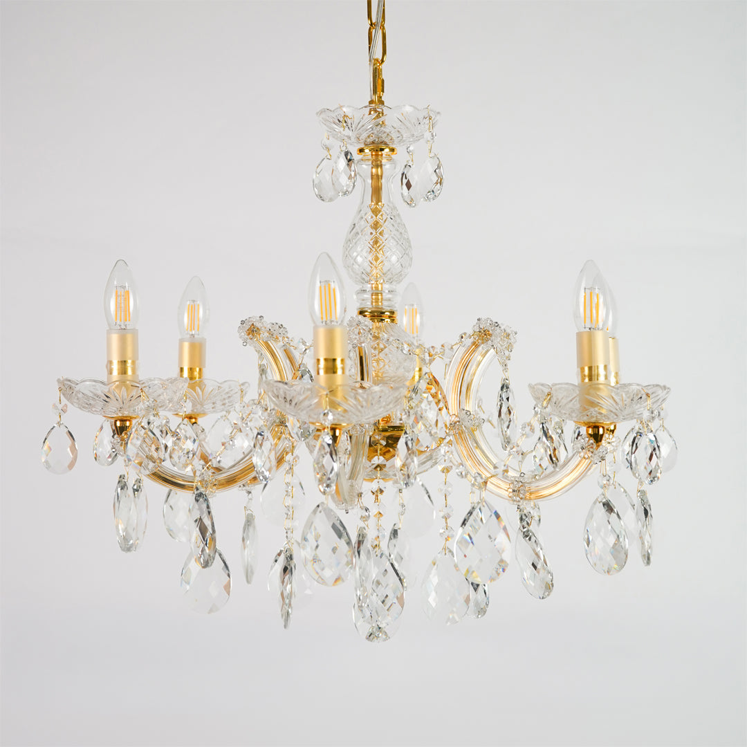 White background image of elegant crystal chandelier for elegant dining room decor styling with unlit crystal arms.