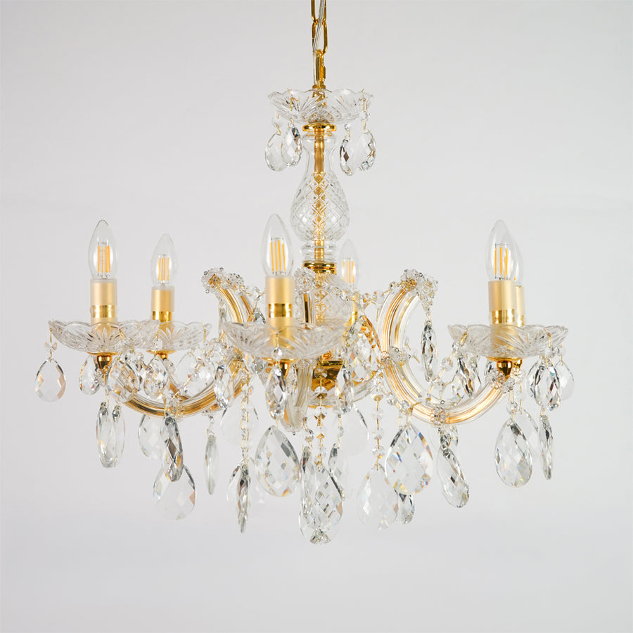 White background image of elegant crystal chandelier for elegant dining room decor styling with unlit crystal arms.