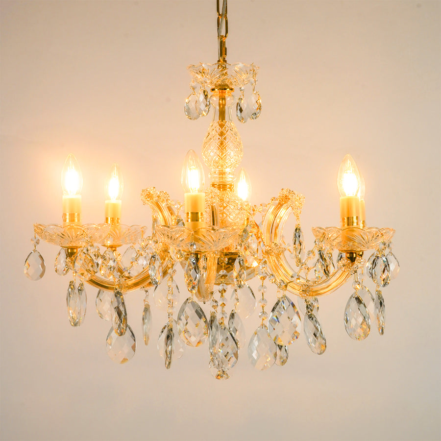 White background image of elegant crystal chandelier for modern living room decor styling with a bright warm glow.