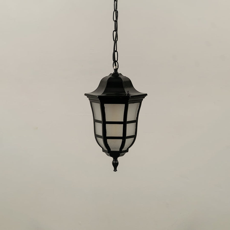 Black metal outdoor hanging lantern lamp with frosted glass panels and chain suspended against a plain white background with light off.