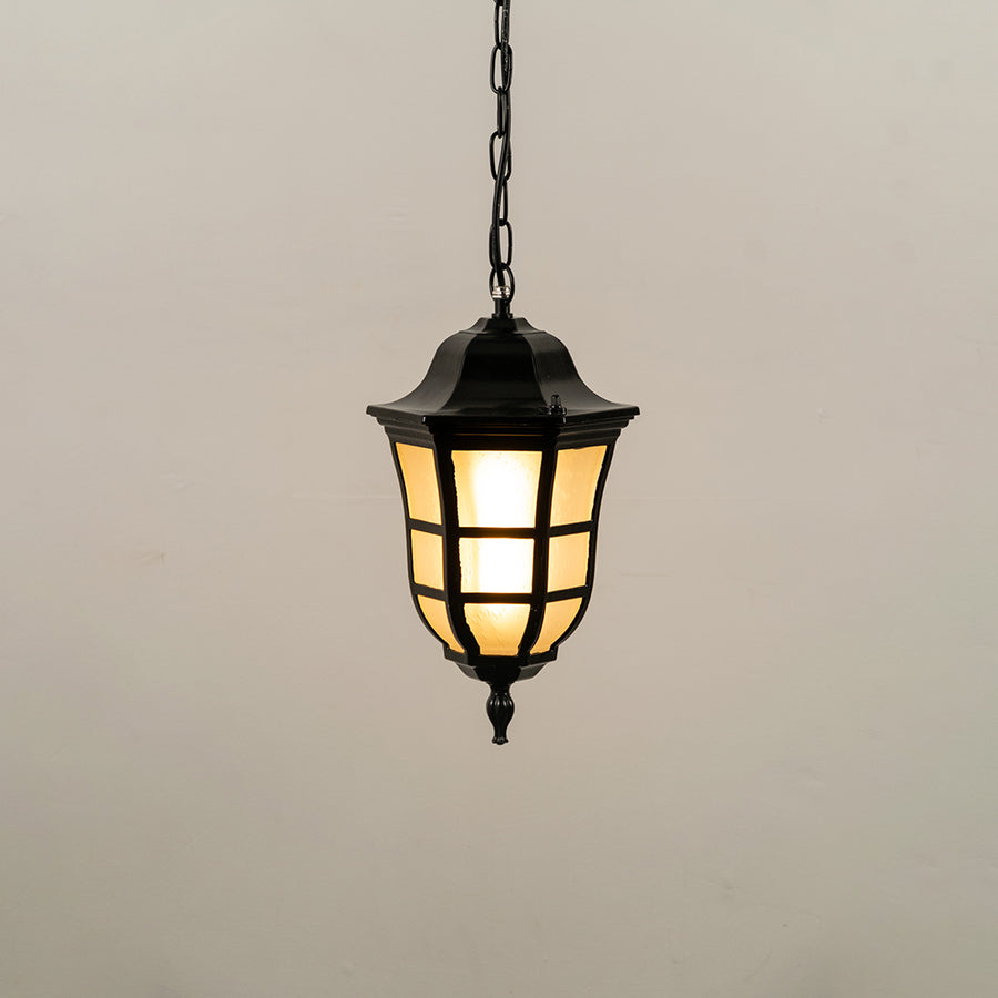 Black metal hanging outdoor lantern with glass panels glowing on white background ideal for gate entrance and exterior lighting decor.