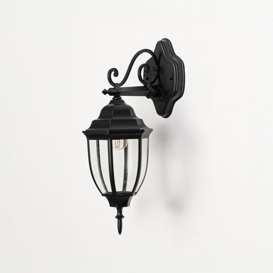 Outdoor wall lantern light off on white background showing black metal construction clear glass panels and vintage inspired wall mount design.