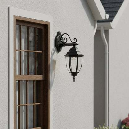 Outdoor wall lantern mounted beside a house window enhancing exterior decor with a classic black finish and elegant design in a bright daytime setting.