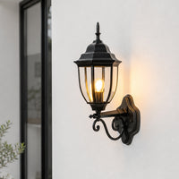 Traditional black metal outdoor wall lantern for porch entrance balcony and exterior walls with warm ambient lighting.