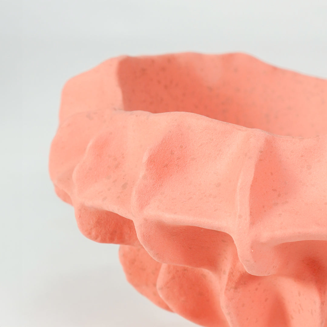 Closeup image of pink ceramic abstract decor bowl for modern tabletop styling with artistic textured finish display.