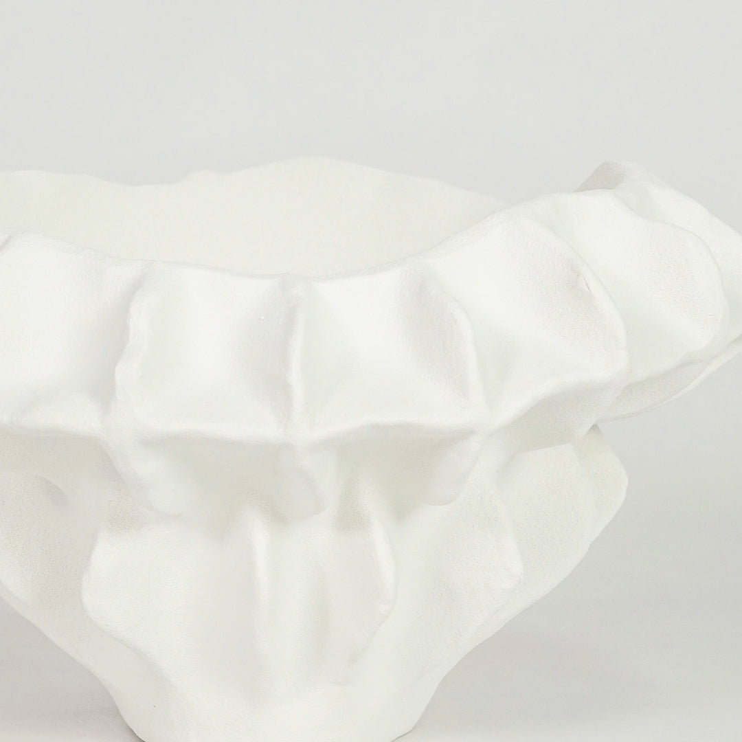 Closeup image of white ceramic textured decor bowl for modern dining table styling with elegant artistic finish.