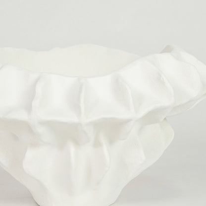 Closeup image of white ceramic textured decor bowl for modern dining table styling with elegant artistic finish.