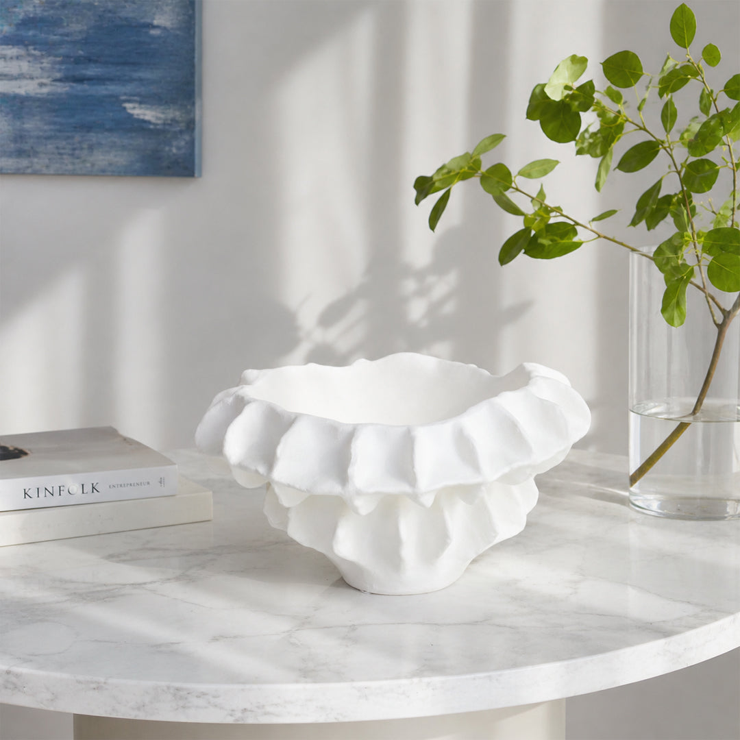 White textured ceramic planter bowl placed on marble table for elegant modern living room decor styling.