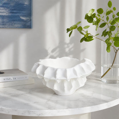 White textured ceramic planter bowl placed on marble table for elegant modern living room decor styling.