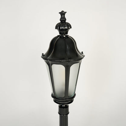 Close view of black outdoor lantern pole light with glass enclosure showcasing classic weather resistant exterior lighting design.

