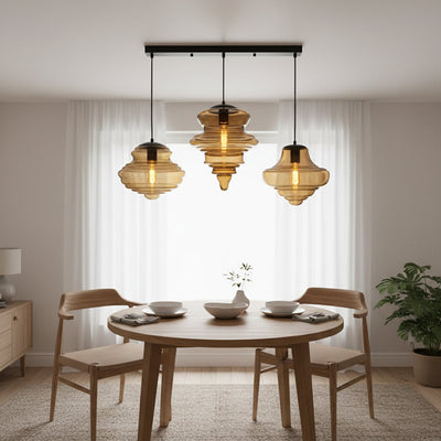 Amber glass pendant lights adding warm elegance above the dining table in contemporary interiors.