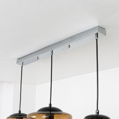 Closeup of amber ribbed glass pendant light highlighting layered texture and premium craftsmanship.