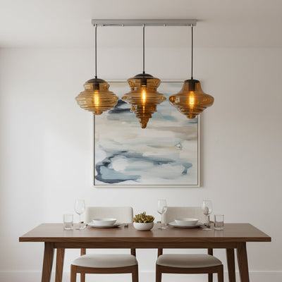 Amber glass pendant lights adding warm elegance above the dining table in modern interiors.