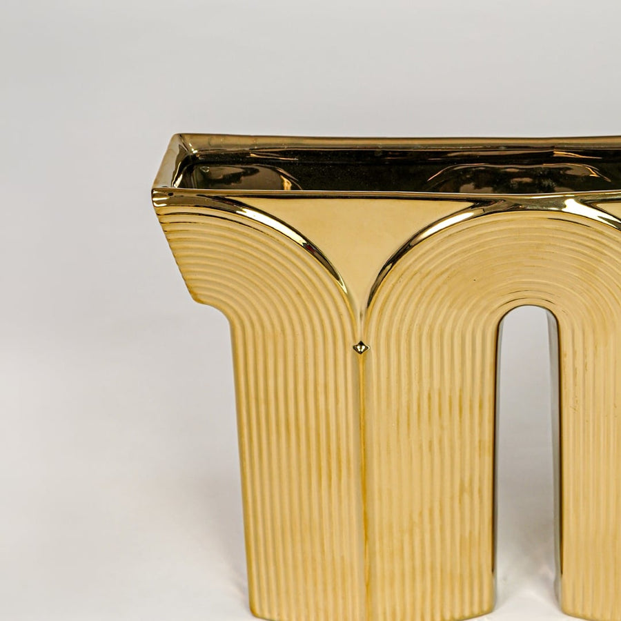 Gold metal decorative sculpture closeup with textured finish modern showpiece for table console shelf home decor styling.