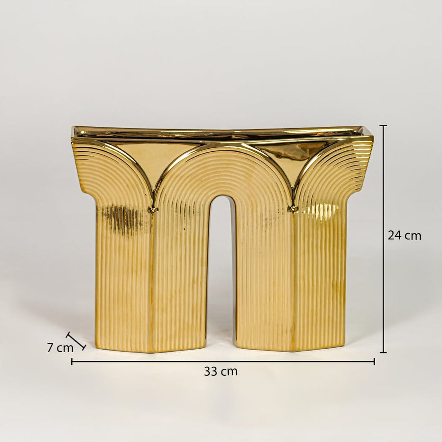 Gold metal decorative sculpture size 24 cm height 33 cm width 7 cm depth modern showpiece for console table styling.