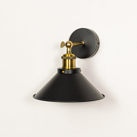 Wall mounted black metal light with gold accents switched off on white background showing matte texture elegant shape and build quality.