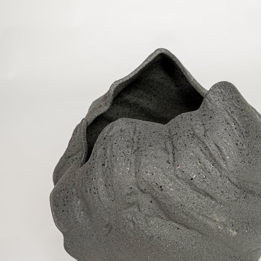 vintage cast black ceramic vase closeup