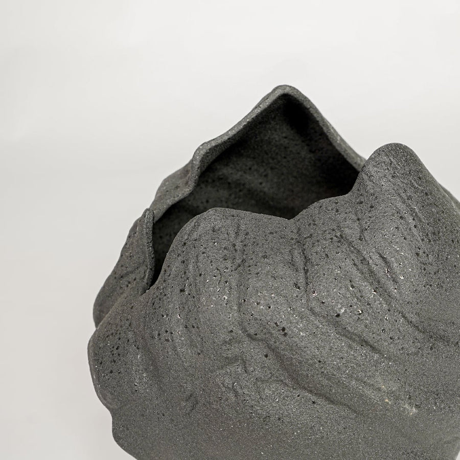 vintage cast black ceramic vase closeup