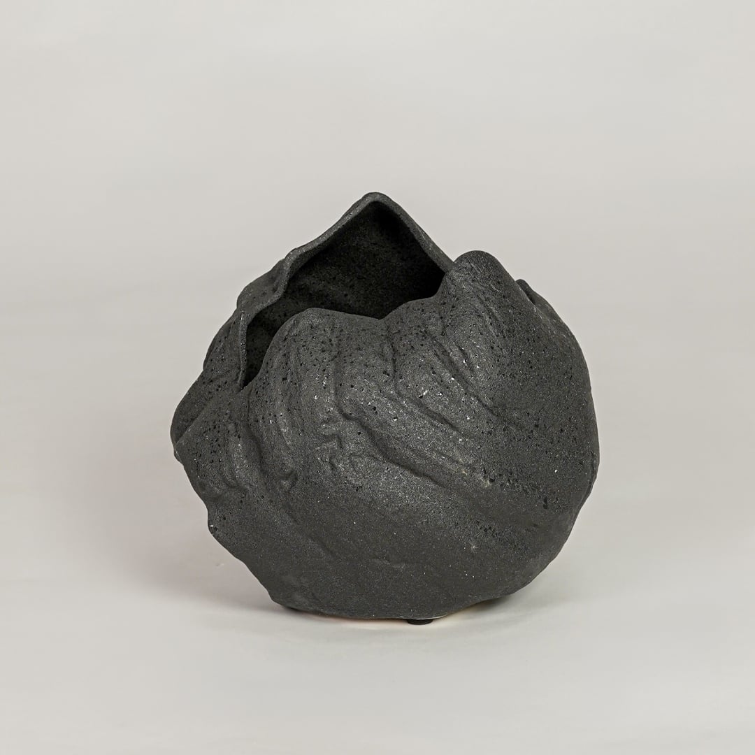 vintage cast black ceramic vase white background