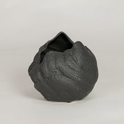 vintage cast black ceramic vase white background