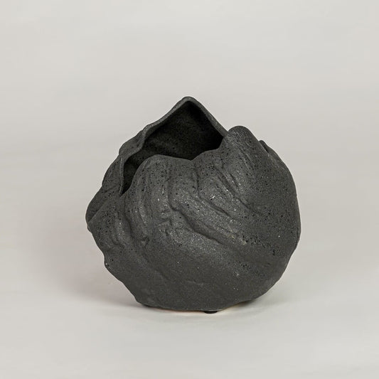 vintage cast black ceramic vase white background