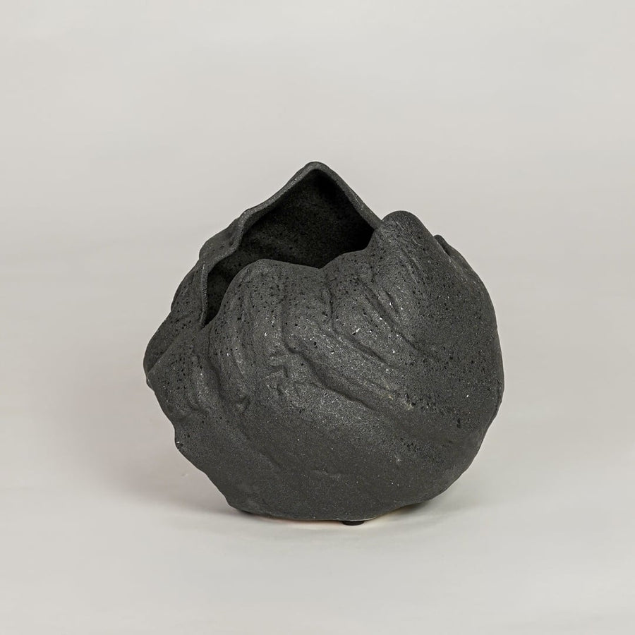 vintage cast black ceramic vase white background