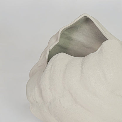 Closeup white textured ceramic vase surface detail modern decorative flower vase for table shelf console decor.