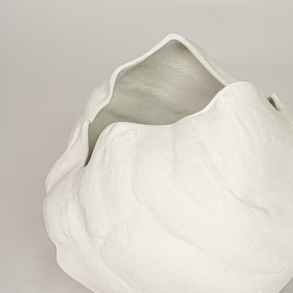 vintage cast white ceramic vase closeup