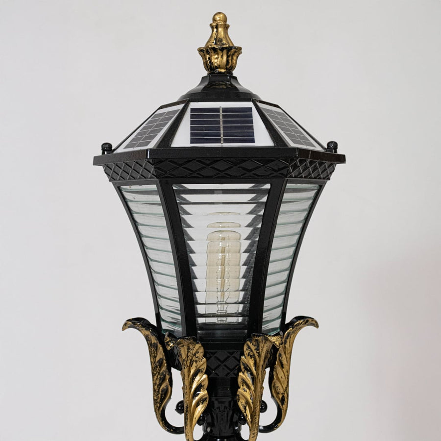 Closeup of black metal outdoor lantern light with solar panel top for elegant exterior lighting decor styling.