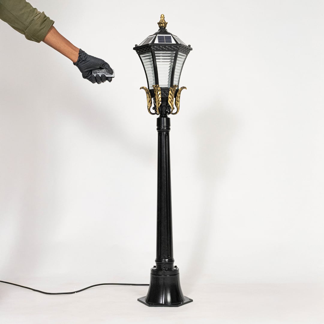 Black metal outdoor lantern post light with classic design for elegant garden pathway lighting decor.