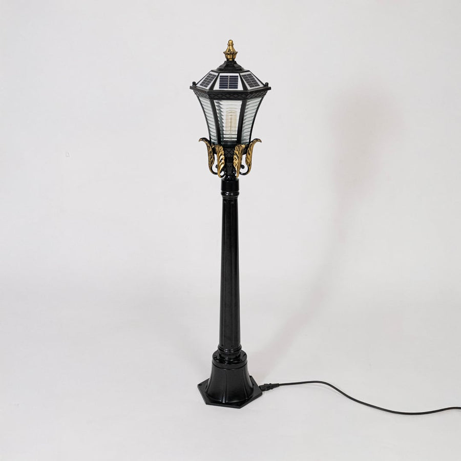 Black metal outdoor lantern post light with glass panels for modern exterior lighting decor placement styling.